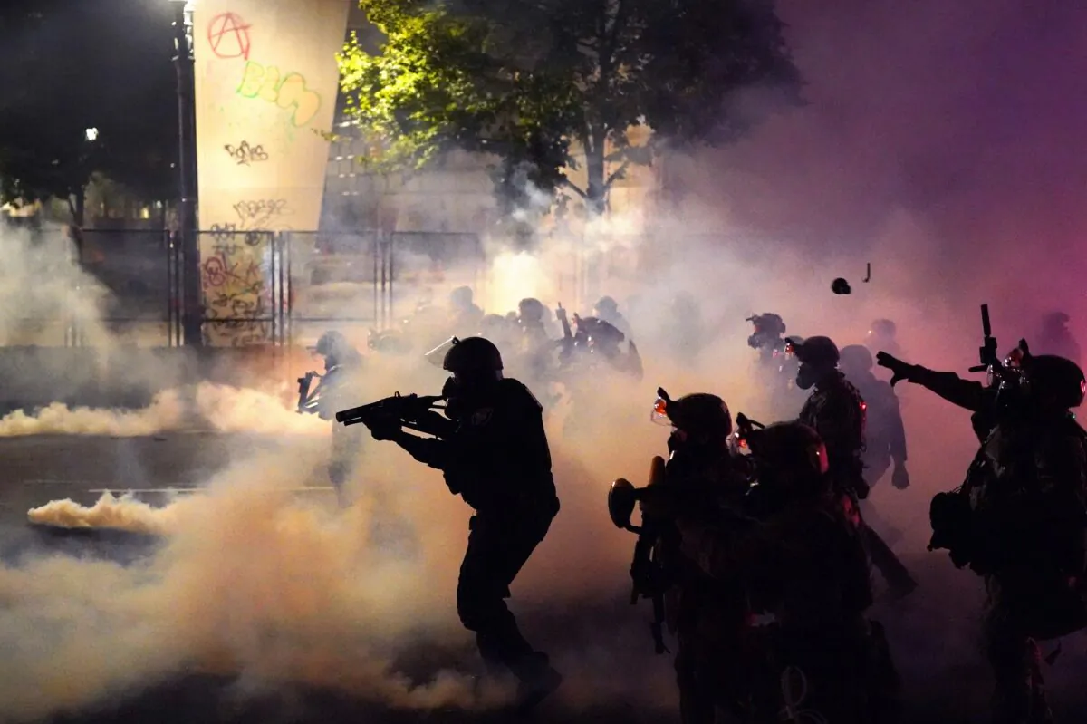 Federal officers deploy tear gas and less-lethal munitions while dispersing a crowd from the Mark O. Hatfield Courthouse in Portland, Ore., on July 24, 2020. (Nathan Howard/Getty Images)