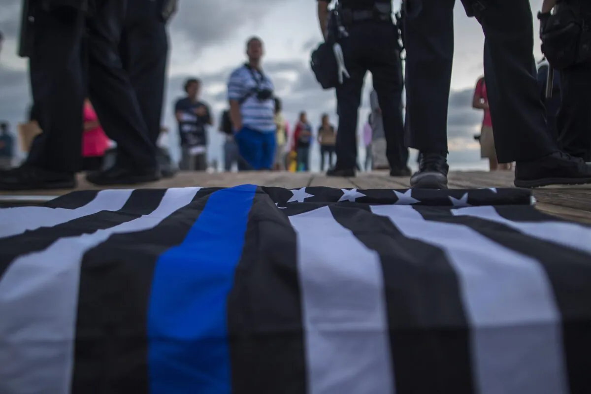 A flag with the thin blue line, which is used to honor police officers, lies on a boardwalk in a file photograph. (David McNew/Getty Images)