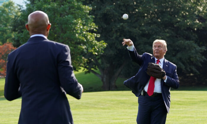 President Donald Trump plays catch with former Hall of Fame pitcher Mariano Rivera while hosting youth baseball players at the White House on opening day for Major League Baseball, in Washington on July 23, 2020. (Kevin Lamarque/Reuters)