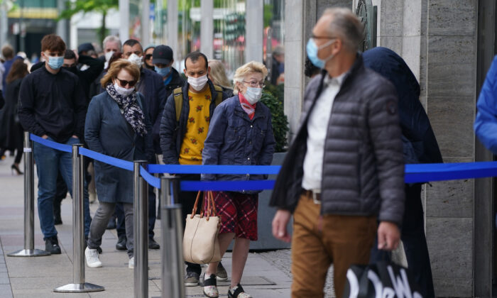 Shoppers wearing face masks wait to enter the KaDeWe department store Berlin, Germany, in a file photo. (Photo by Sean Gallup/Getty Images)