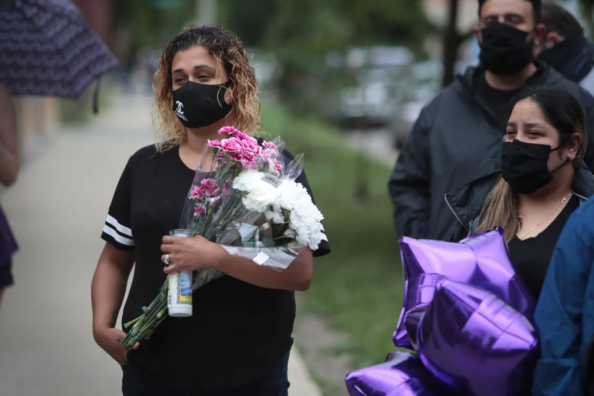 Friends, family, and residents of Chicago’s Logan Square neighborhood attend a vigil on June 29, 2020, for 10-year-old Lena Nunez, one of 17 people fatally shot in the city the last weekend of June. (Scott Olson/Getty Images)