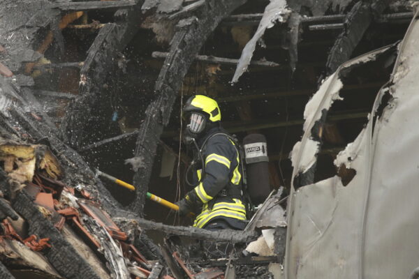 Emergency services attend the scene after a light plane crashed into an apartment building
