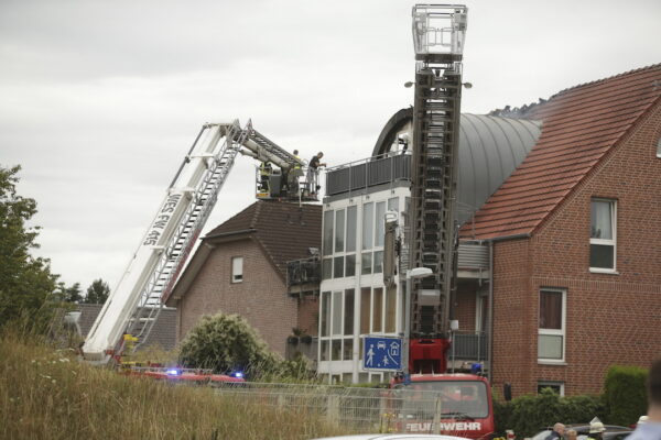 Emergency services attend the scene after a light plane crashed into an apartment building