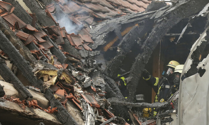 Emergency services attend the scene after a light plane crashed into an apartment building in Wesel, Germany, on July 25, 2020. David Young/dpa via AP)