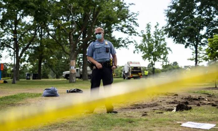 A Minneapolis police officer stands in a park in Minneapolis, Minn., on July 20, 2020. (Stephen Maturen/Getty Images)