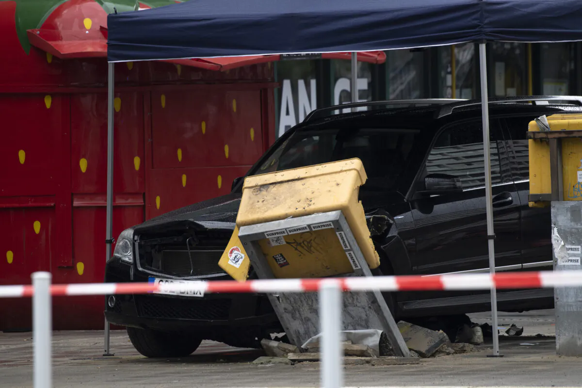 A car is parked after a collision with a group of people at Hardenbergplatz near a destroyed mailbox in Berlin Sunday, on July 26, 2020. The car drove off the road and into pedestrians. (Paul Zinken/dpa-Zentralbild/AP Photo)