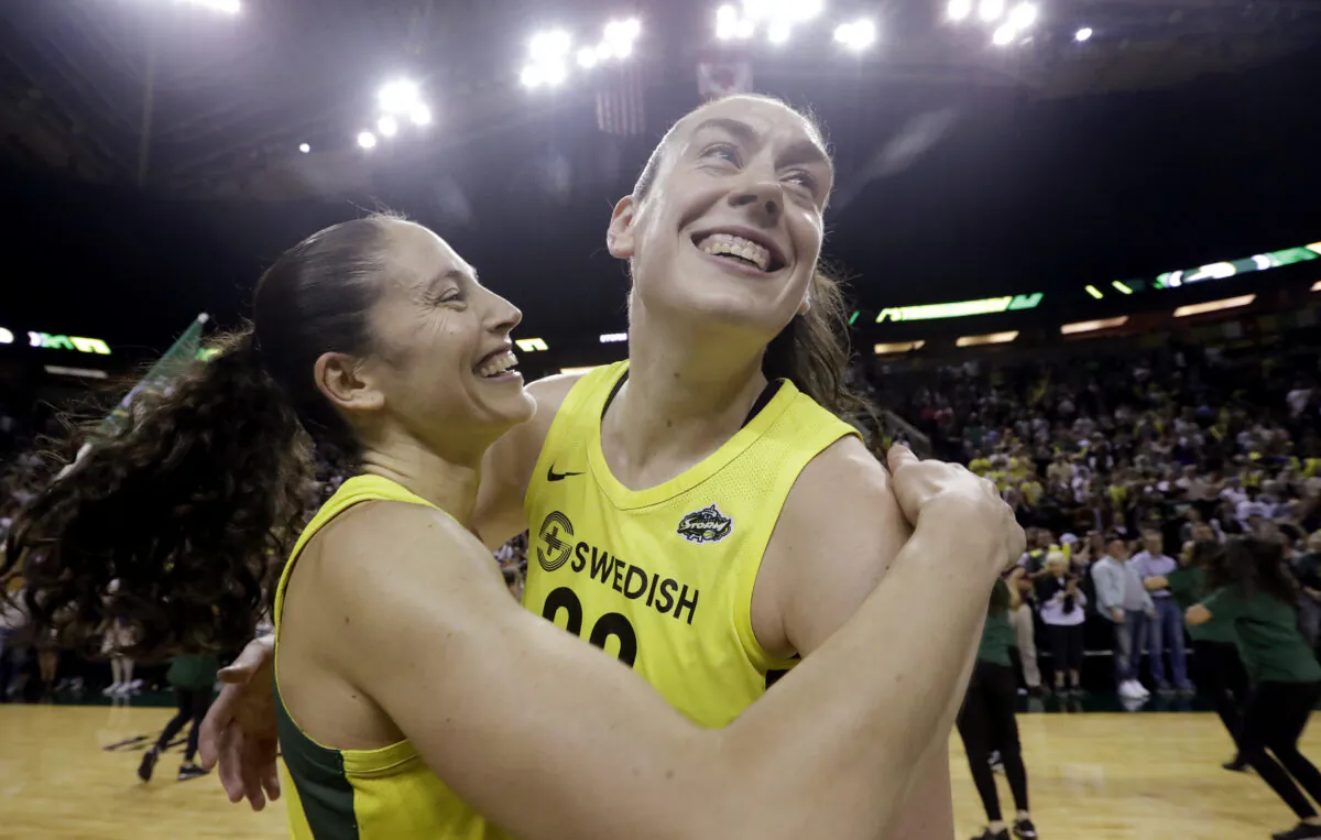 This Sept. 4, 2018, file photo shows Seattle Storm's Sue Bird, left, and Breanna Stewart embracing after the Storm defeated the Phoenix Mercury 94-84 during Game 5 of a WNBA basketball playoff semifinal, in Seattle. (AP Photo/Elaine Thompson)