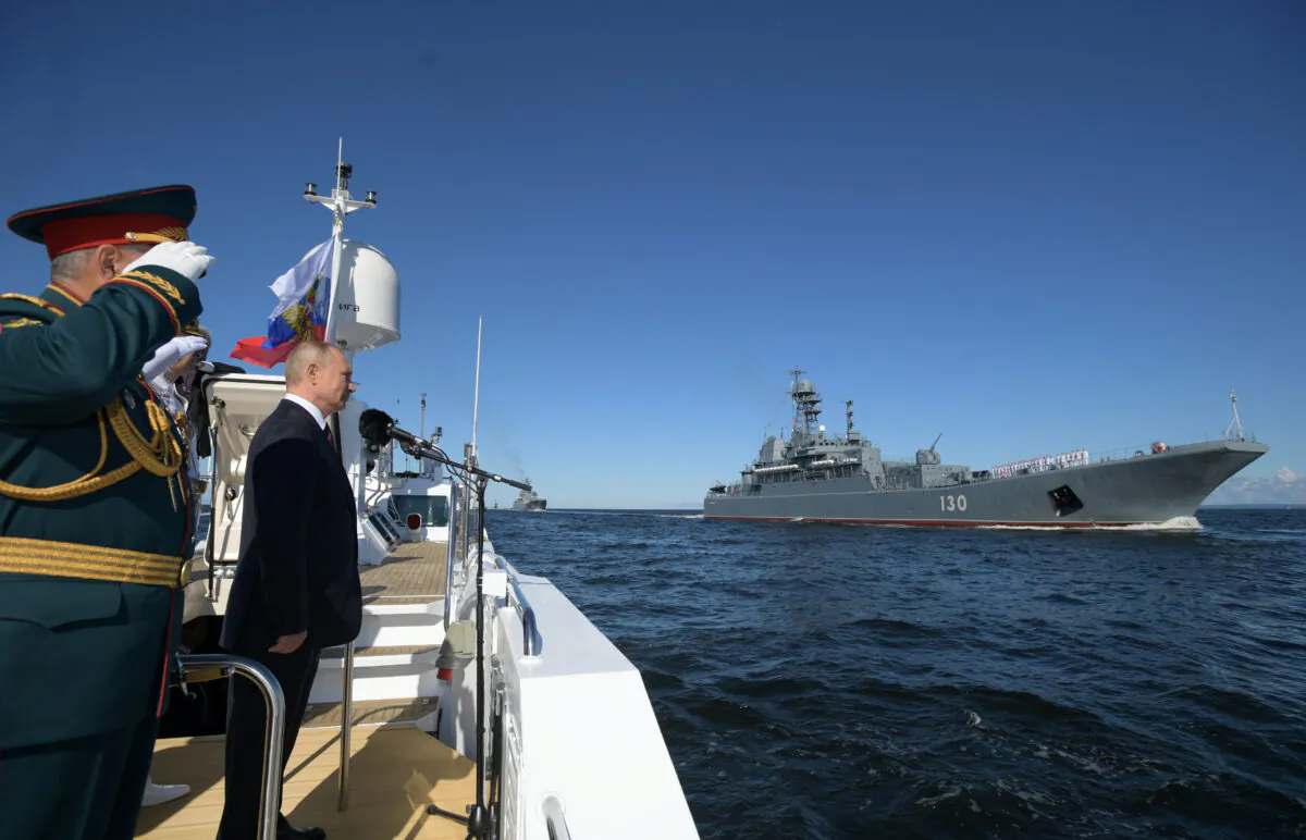 Russia's President Vladimir Putin inspects warships before the Navy Day parade in Saint Petersburg, Russia, on July 26, 2020. (Sputnik/Alexei Druzhinin/Kremlin via Renters)