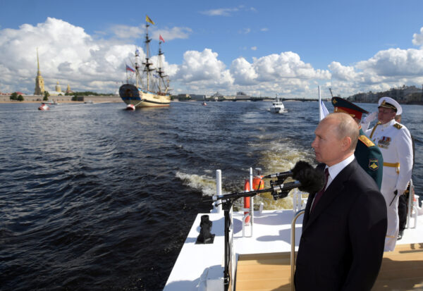 Vladimir Putin inspects warships on the Neva river during the Navy Day
