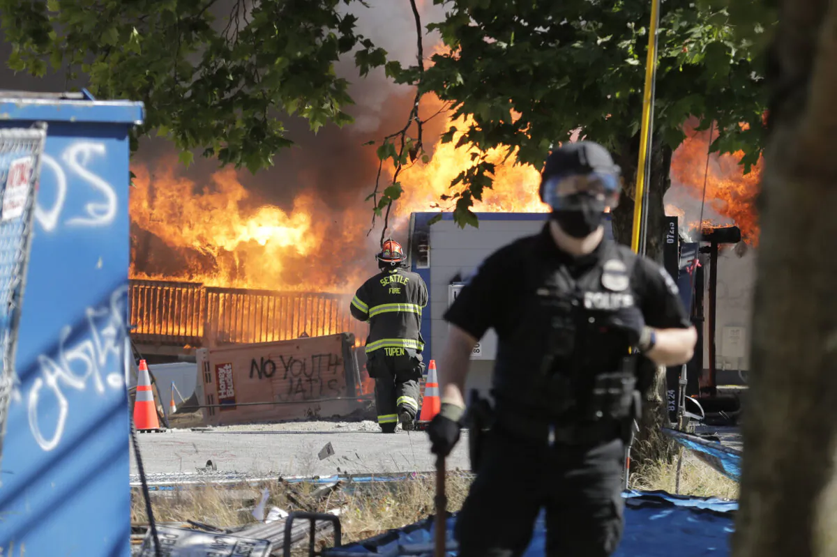 Construction buildings burn near the King County Juvenile Detention Center during rioting in Seattle, Wash., on July 25, 2020. (Ted S. Warren/AP Photo)
