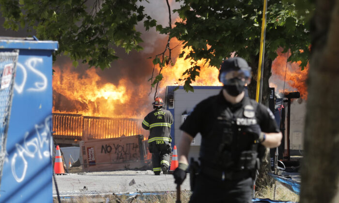 Construction buildings burn near the King County Juvenile Detention Center during rioting in Seattle, Wash., on July 25, 2020. (Ted S. Warren/AP Photo)