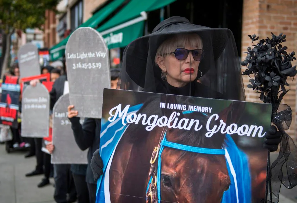 Members of the group Horseracing Wrongs and their supporters hold a "Requiem March for the fallen horses," in Pasadena, Calif., on Nov. 30, 2019. (Mark Ralston/AFP via Getty Images)