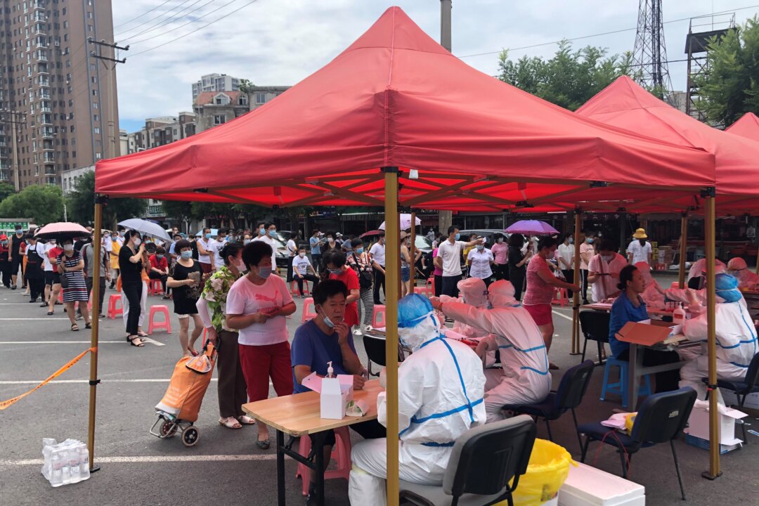 People are lining up to take COVID-19 tests at a makeshift testing center in Dalian, in China's northeast Liaoning Province on July 26, 2020. (STR/AFP via Getty Images)