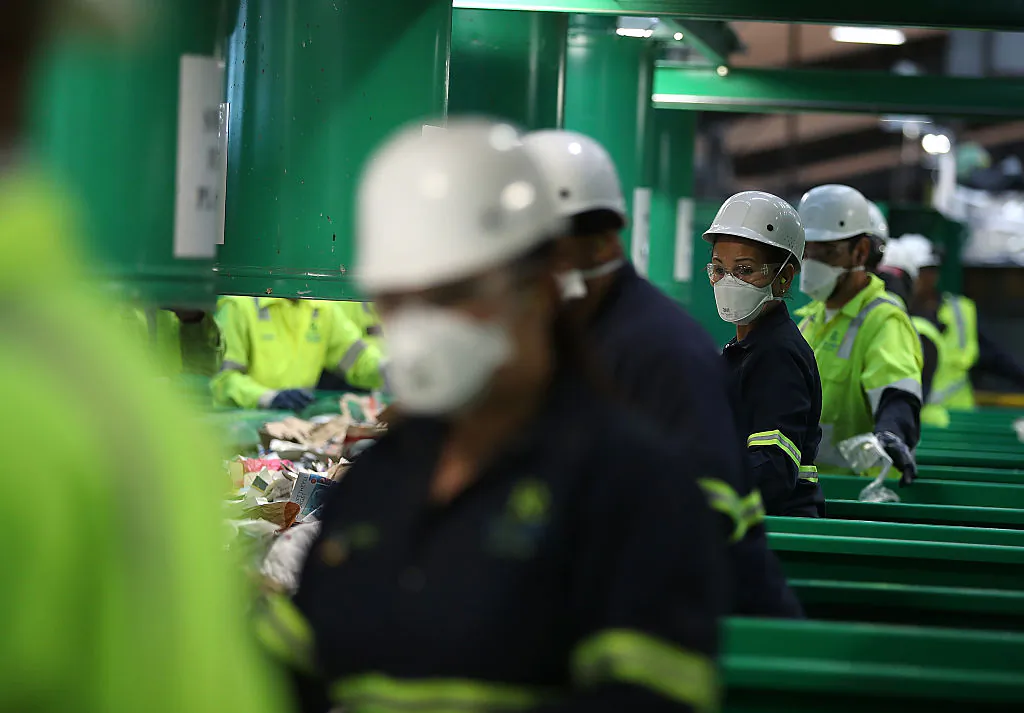 SAN FRANCISCO, CA - NOVEMBER 16:  Workers sort recyclable materials as they pass through a sorting machine at Recology's Recylce Central on November 16, 2016 in San Francisco, California. Recology has installed a state-of-the-art recycling system at their 200,000 square foot Recycle Central facility that is capable of increasing their daily processing of recyclable materials by 170 tons.  (Photo by Justin Sullivan/Getty Images)