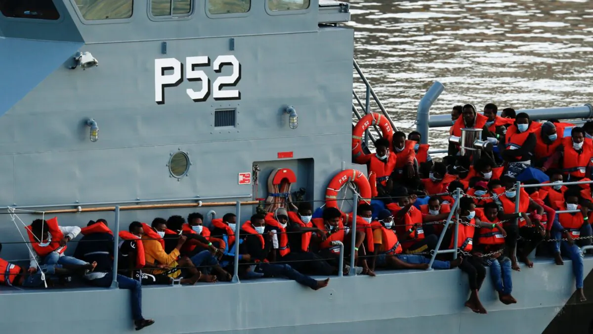 Rescued migrants are seen on an Armed Forces of Malta's vessel after arriving in Senglea, in Valletta's Grand Harbor, Malt, on July 27, 2020. (Darrin Zammit Lupi/Reuters)
