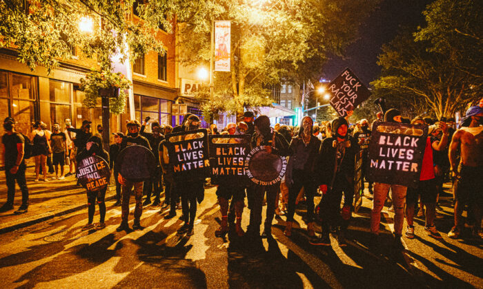 People carrying homemade Black Lives Matter shields march in front of protesters in Richmond, Va., on July 25, 2020. (Eze Amos/Getty Images)