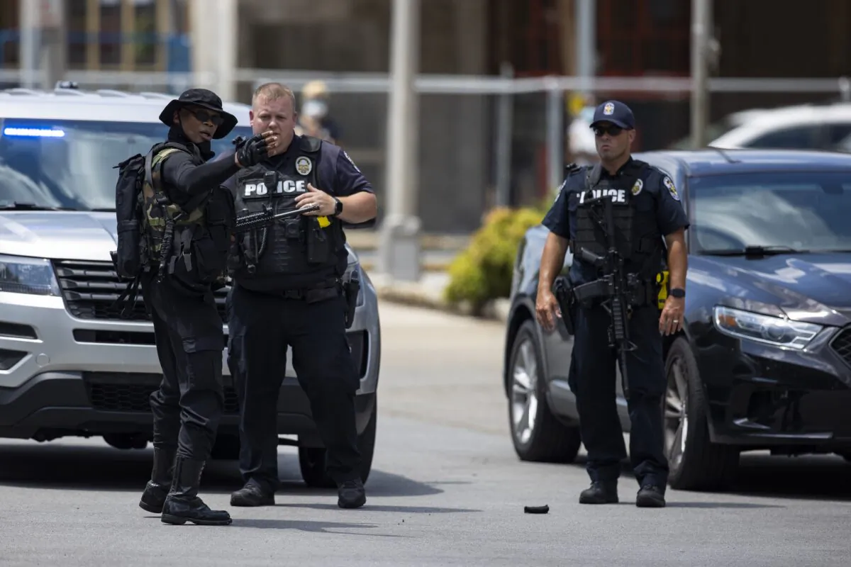 Grandmaster Jay, left, leader of NFAC, speaks with police before a march of his group and supporters in Louisville, Ky., on July 25, 2020. (Brett Carlsen/Getty Images)