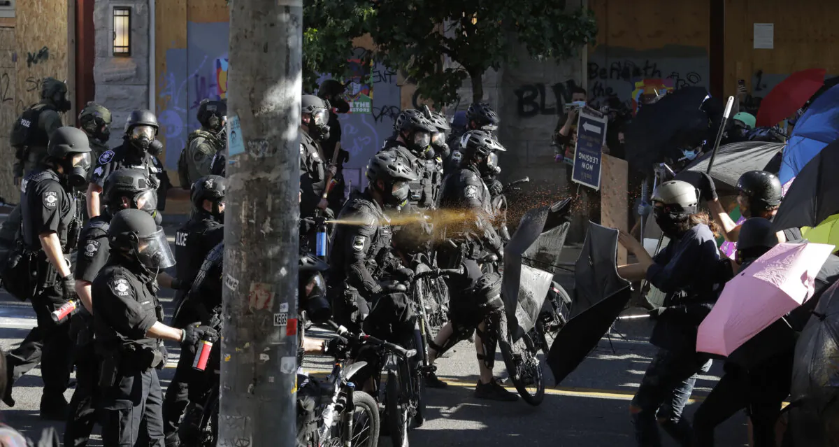 Police pepper spray demonstrators amid rioting near Seattle Central Community College in Seattle, Wash., on July 25, 2020. (Ted S. Warren/AP Photo)