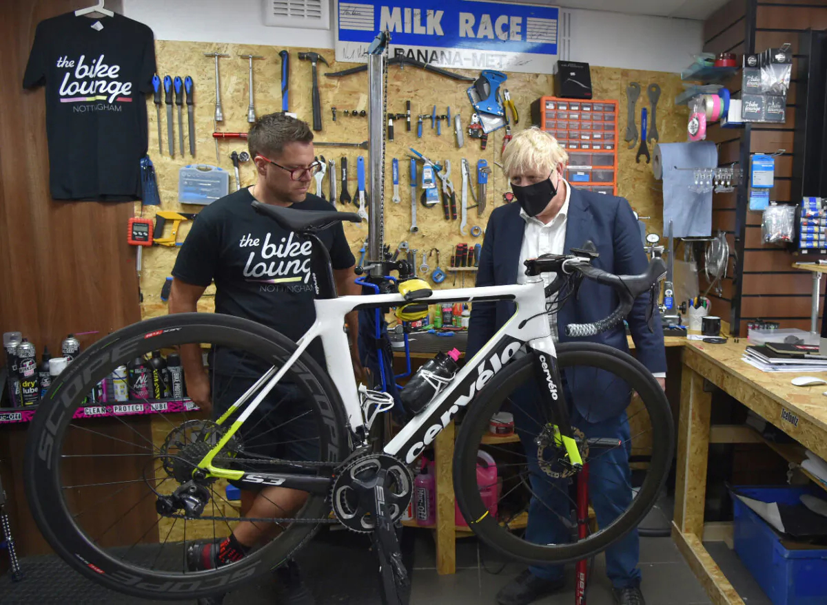 Boris Johnson wears a face mask as he talks to the owner of the Cycle Lounge, in Beeston near Nottingham, England, on July 28, 2020 (Rui Vieira - WPA Pool/Getty Images)