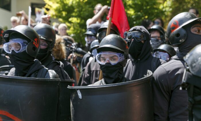 Antifa members prepare to clash with Patriot Prayer protesters during a rally in Portland, Ore., on Aug. 4, 2018. (John Rudoff/AP Photo)