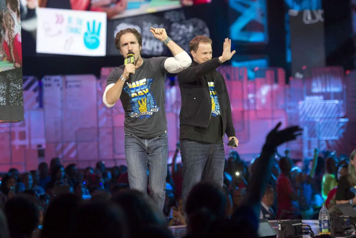 WE Charity co-founders Craig Kielburger (L) and Marc Kielburger speak during We Day in Toronto on Oct. 2, 2014. (The Canadian Press/Hannah Yoon)