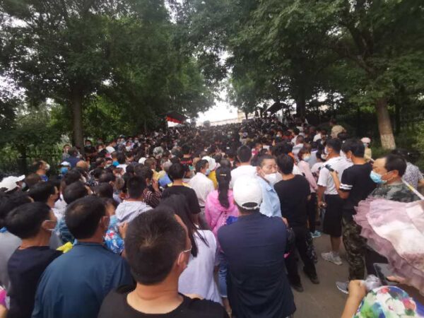 Residents are crowded together at a COVID-19 nucleic acid test site in Dalian, China, on July 27, 2020. (Provided to The Epoch Times)