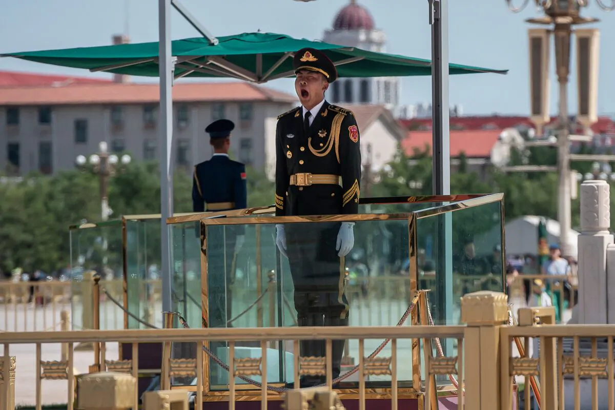 A Chinese paramilitary soldier yawns as he stands guard on Tiananmen Square in Beijing on June 4, 2020. (Nicolas Asfouri/AFP via Getty Images)