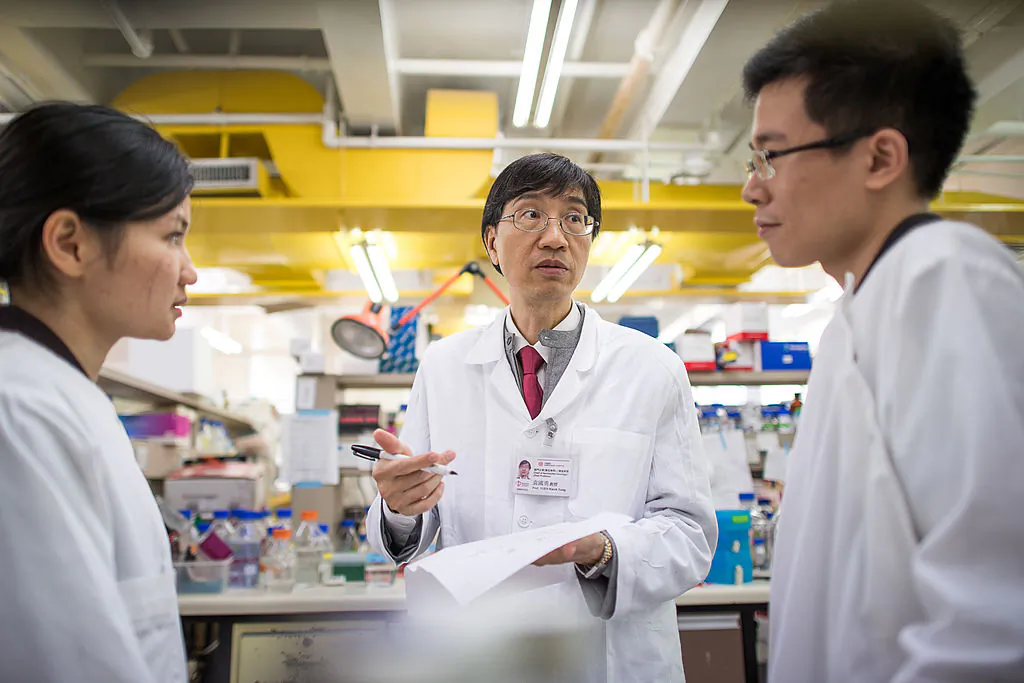 Yuen Kwok-yung (C) at a laboratory of Hong Kong University's Department of Microbiology at Queen Mary Hospital in Hong Kong, on March 11, 2013. (Philippe Lopez /AFP via Getty Images)