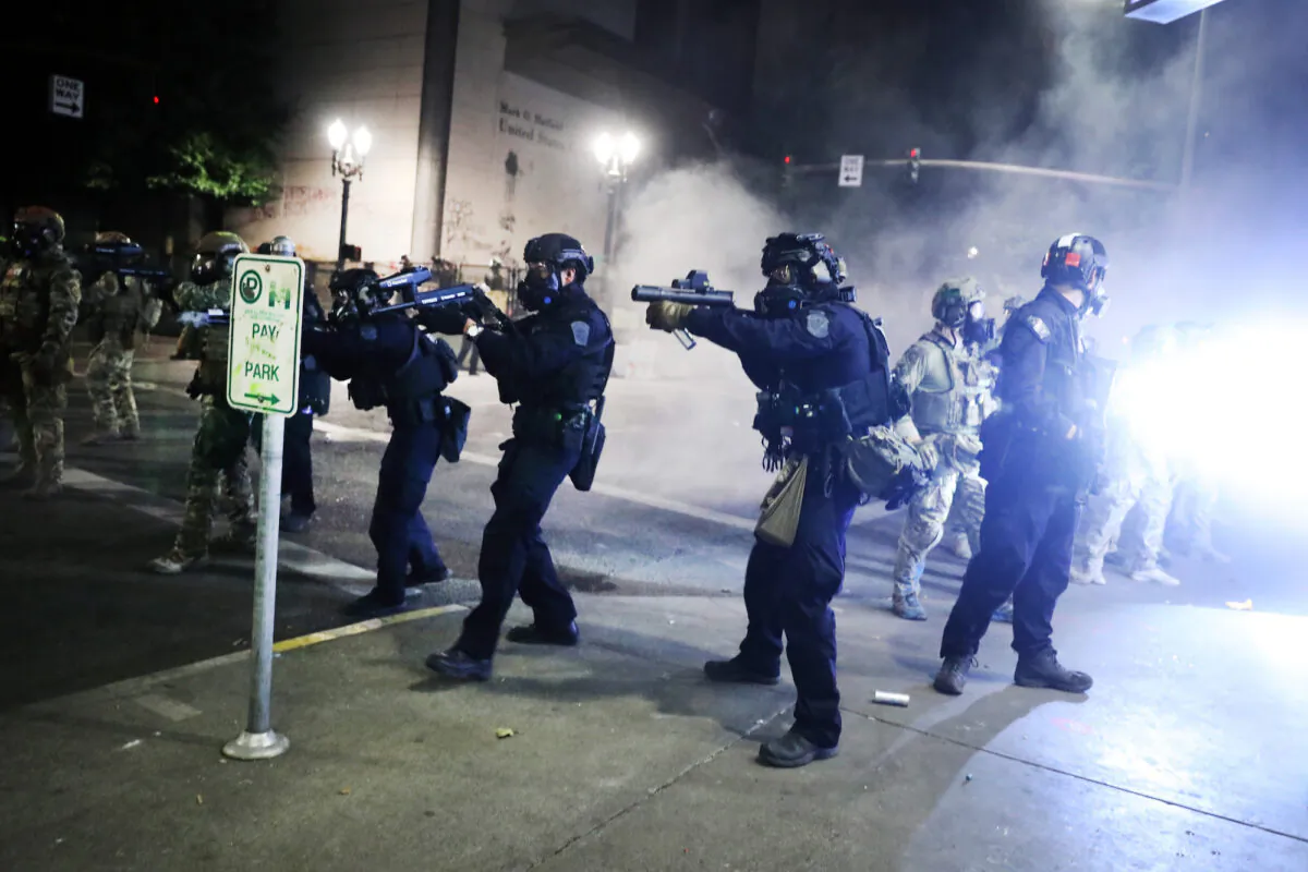 Federal police face off with protesters in front of the Mark O. Hatfield federal courthouse in downtown Portland as the city experiences another night of unrest in Portland, Oregon, on July 27, 2020. (Spencer Platt/Getty Images)