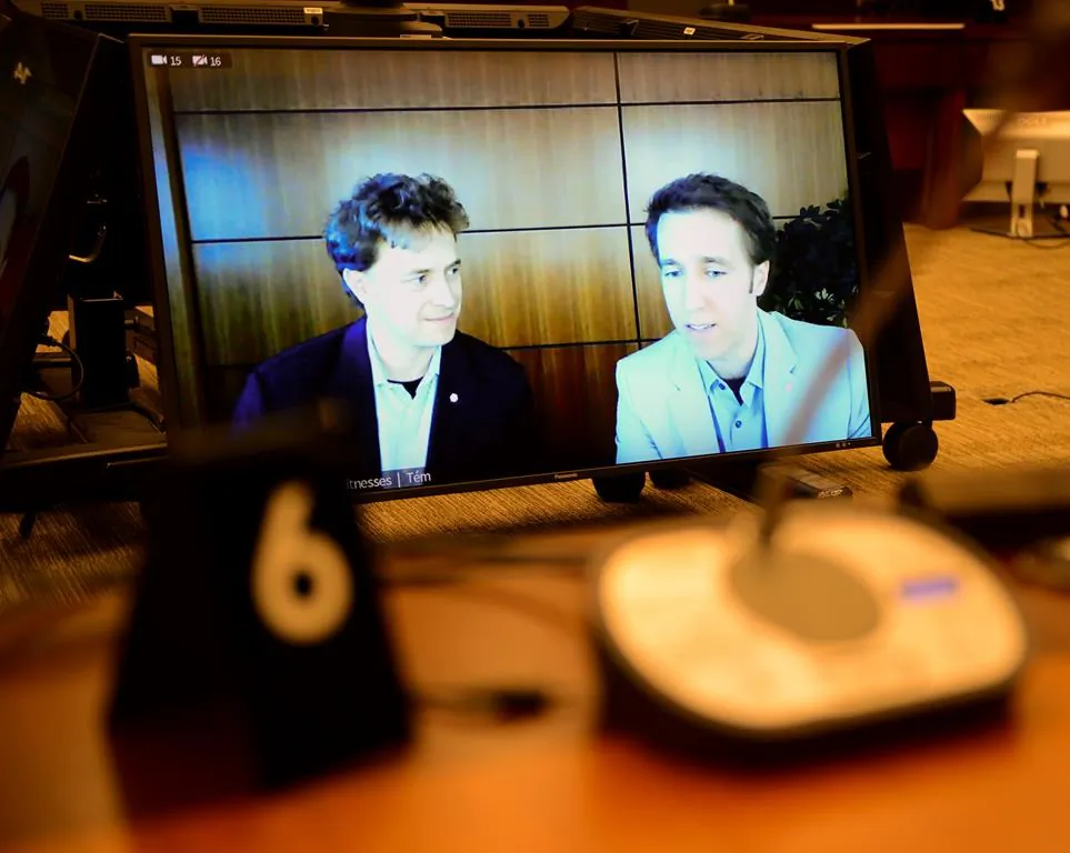 Marc Kielburger, screen left, and Craig Kielburger, screen right, appear as witnesses via videoconference during a House of Commons finance committee in the Wellington Building in Ottawa on July 28, 2020. The committee is looking into Government Spending, WE Charity and the Canada Student Service Grant. (Sean Kilpatrick/The Canadian Press)