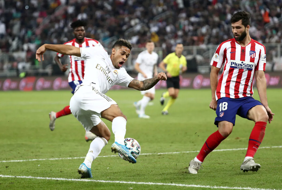 Real Madrid's Mariano Diaz (L) in action with Atletico Madrid's Felipe during the Spanish Super Cup Final at King Abdullah Sports City, Jeddah, Saudi Arabia, on Jan. 12, 2020. (Sergio Perez/Reuters)