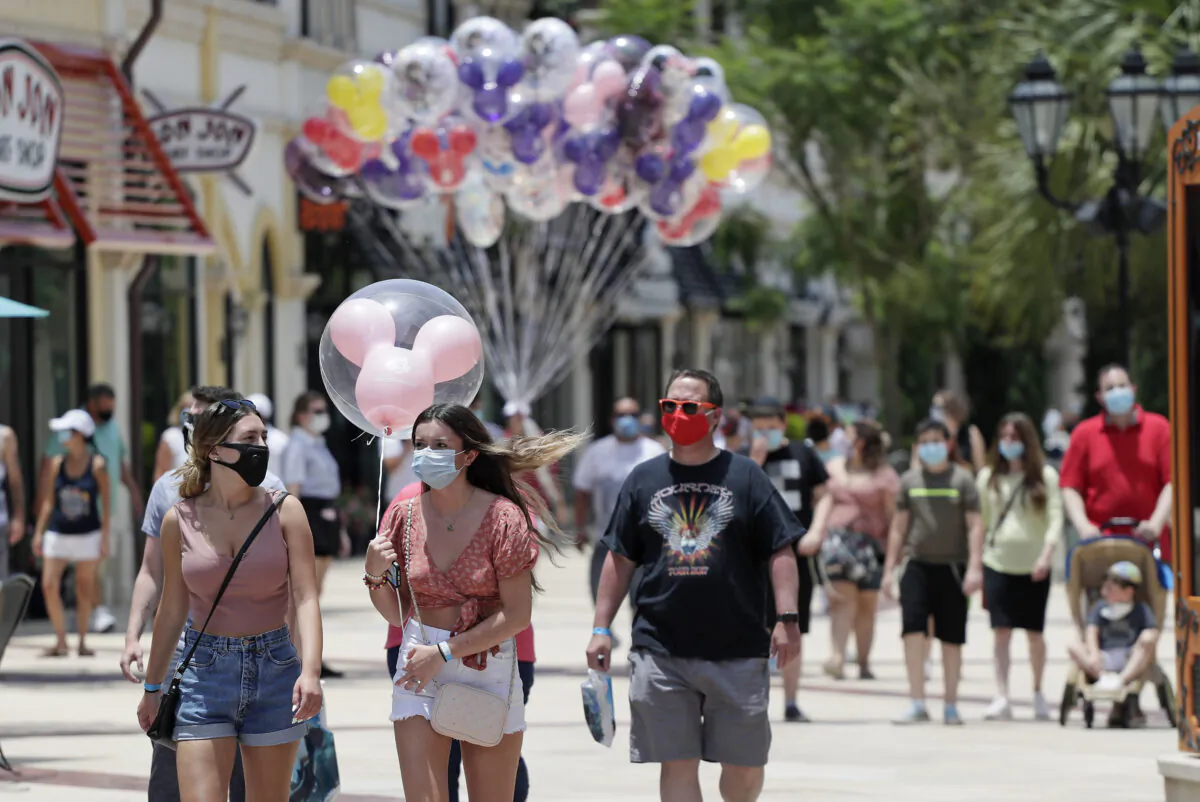 Visitors at Disney Springs walk in Lake Buena Vista, Fla., on June 16, 2020. (John Raoux/AP Photo)