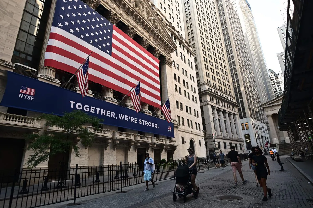 People walk outside the New York Stock Exchange (NYSE) at Wall Street in New York City on July 13, 2020. (Johannes Eisele/AFP via Getty Images)