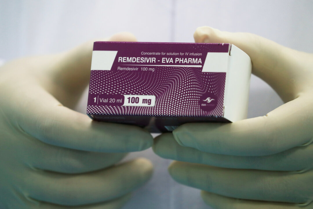 A lab technicians holds the COVID-19 treatment drug "Remdesivir" at Eva Pharma Facility in Cairo, Egypt, on June 25, 2020. (Amr Abdallah Dalsh/Reuters)