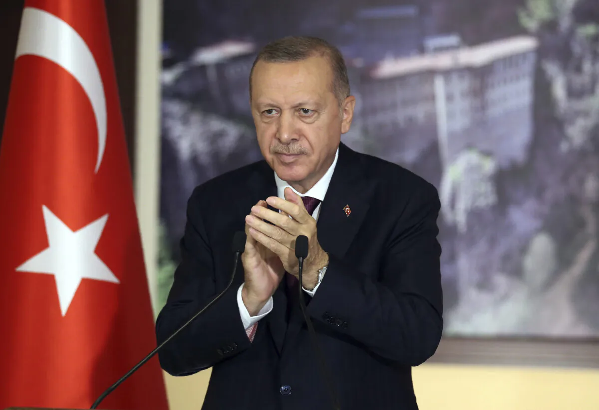 Turkey's President Recep Tayyip Erdogan applauds during a conference in Istanbul, on July 28, 2020. (Turkish Presidency via AP, Pool)