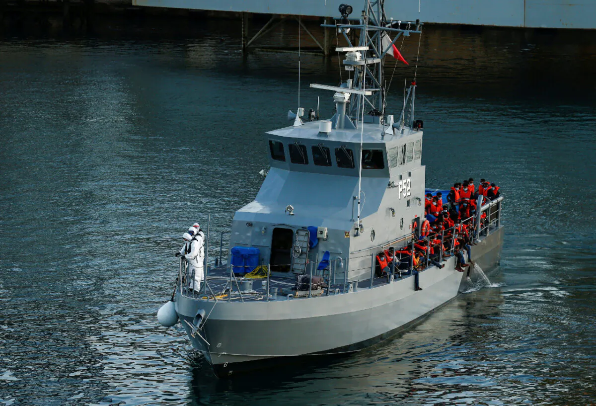 Rescued migrants are seen on an Armed Forces of Malta's vessel after arriving in Senglea, in Valletta's Grand Harbor, Malta, on July 27, 2020. (Darrin Zammit Lupi/Reuters)