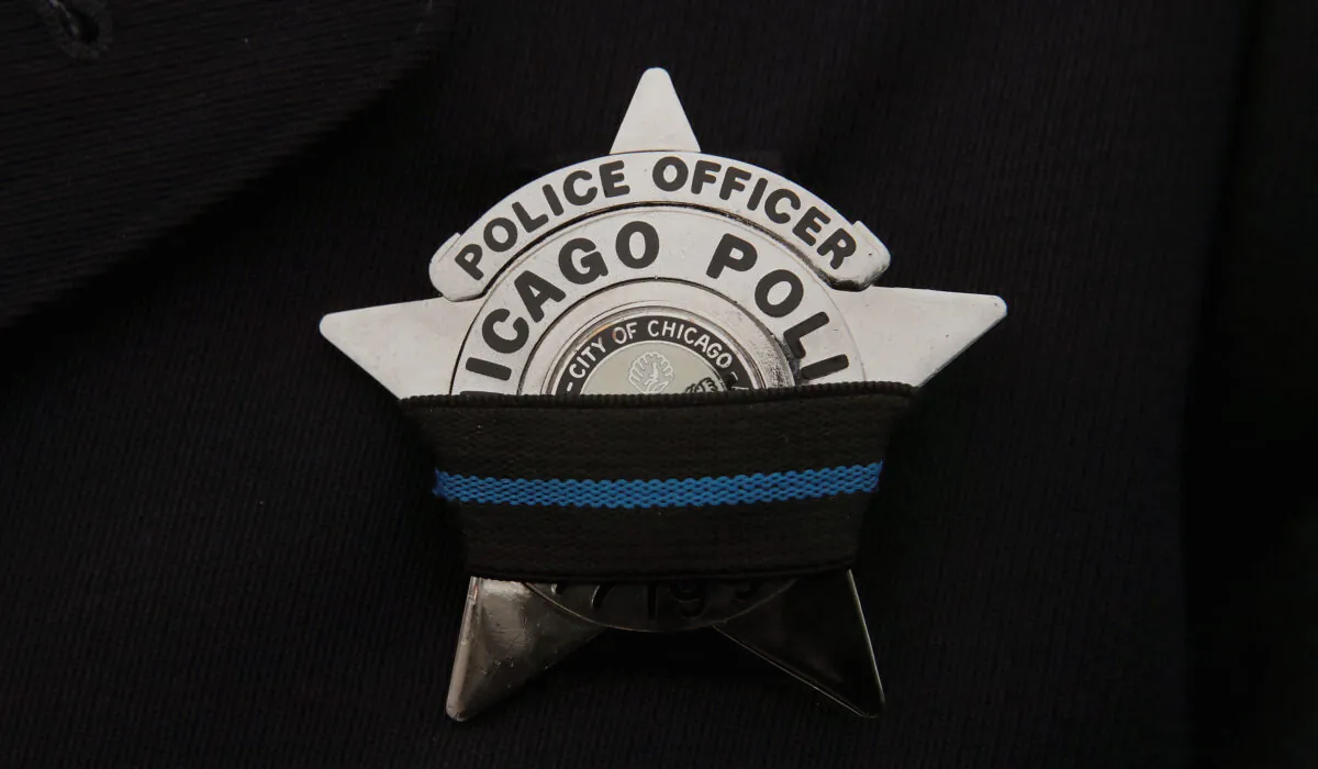 File photo of a Chicago Police Department officer wearing a mourning band on his badge following the death of a colleague, in Des Plaines, Ill., on Nov. 26, 2018. (Scott Olson/Getty Images)