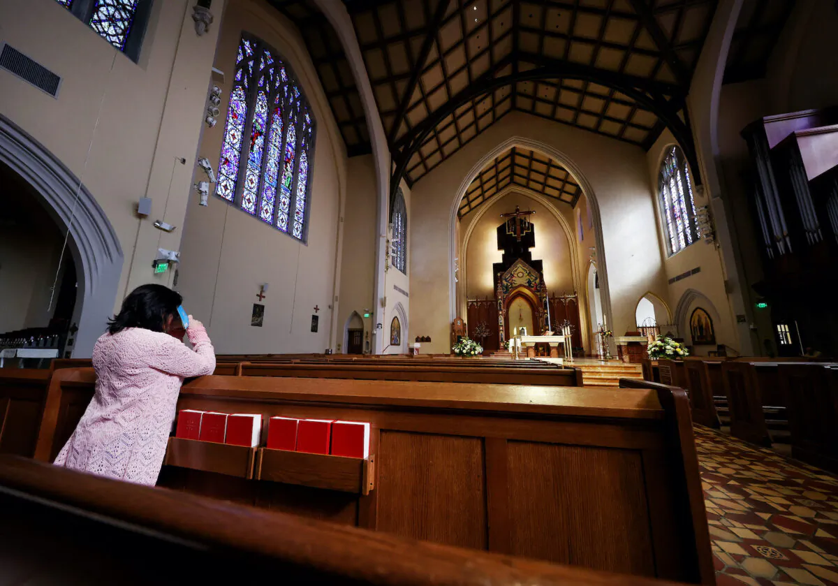  APRIL 12:  A woman prays at the St. Agnes Cathedral on Easter Sunday on April 12, 2020 in Rockville Center, New York.   (Al Bello/Getty Images)