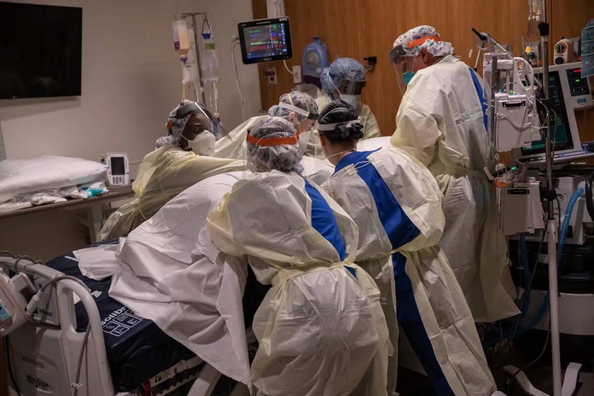 A "prone team," wearing personal protective equipment (PPE), turns a COVID-19 patient onto his stomach in a Stamford Hospital intensive care unit (ICU), on April 24, 2020, in  Connecticut. (John Moore/Getty Images)