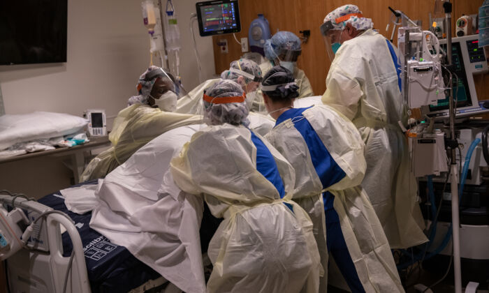 A "prone team," wearing personal protective equipment (PPE), turns a COVID-19 patient onto his stomach in a Stamford Hospital intensive care unit (ICU), on April 24, 2020, in  Connecticut. (John Moore/Getty Images)