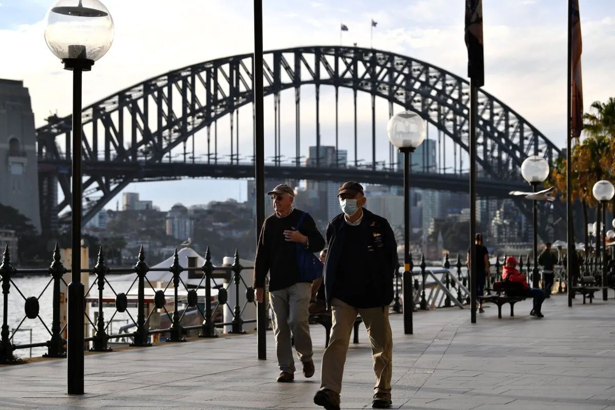 A man wearing a face mask walks before the Harbour Bridge in Sydney, NSW, Australia on July 22, 2020. (Saeed Khan/AFP via Getty Images)