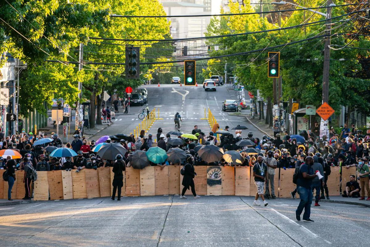 Demonstrators use shields while blocking an intersection near the Seattle Police East Precinct during protests in Seattle on July 26, 2020 in Seattle, Washington. (David Ryder/Getty Images)