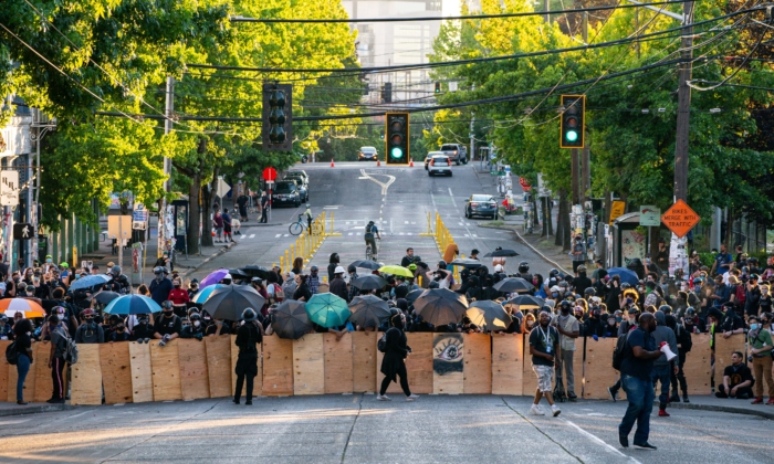 Demonstrators use shields while blocking an intersection near the Seattle Police East Precinct during protests in Seattle on July 26, 2020 in Seattle, Washington. (David Ryder/Getty Images)