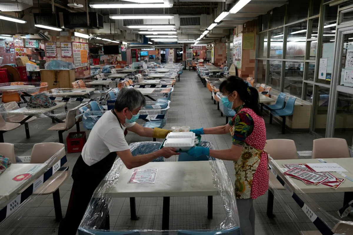 Restaurant employees prepare takeaway meals at a Chinese food court in Hong Kong, on July 29, 2020. (Vincent Yu/AP Photo)