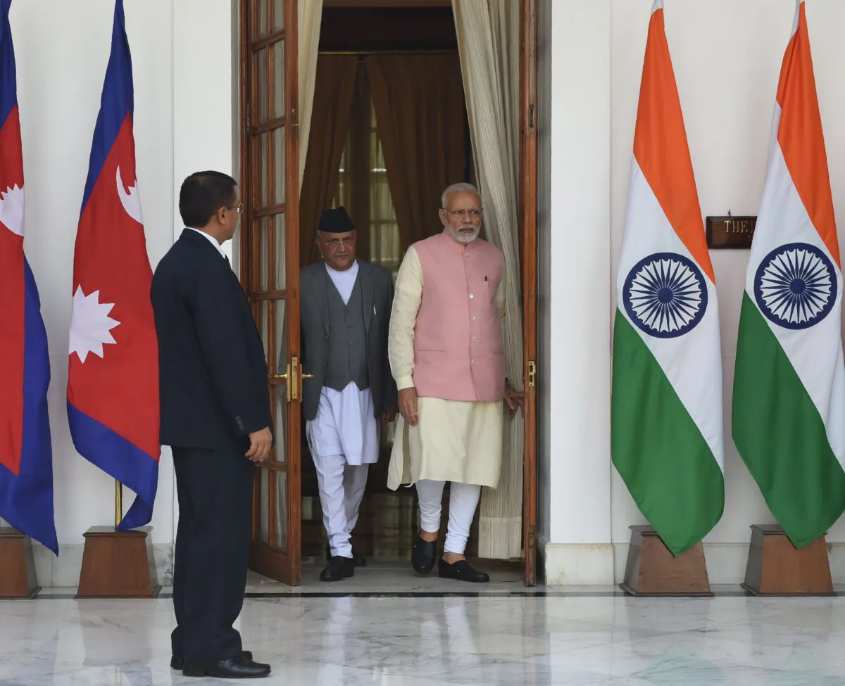 Indian Prime Minister Narendra Modi (R) arrives with Prime Minister of Nepal K.P. Sharma Oli as they arrive for a biliteral meeting at Hyderabad house in New Delhi on April 7, 2018.  / AFP PHOTO / Money SHARMA        (Photo credit should read MONEY SHARMA/AFP via Getty Images)