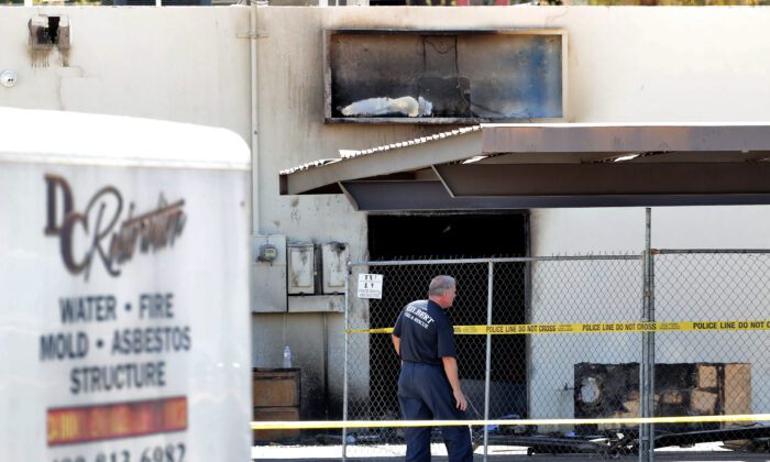 Fire investigators stand outside the Arizona Democratic Party headquarters in Phoenix, Ariz., on July 24, 2020. (Matt York/AP Photo)