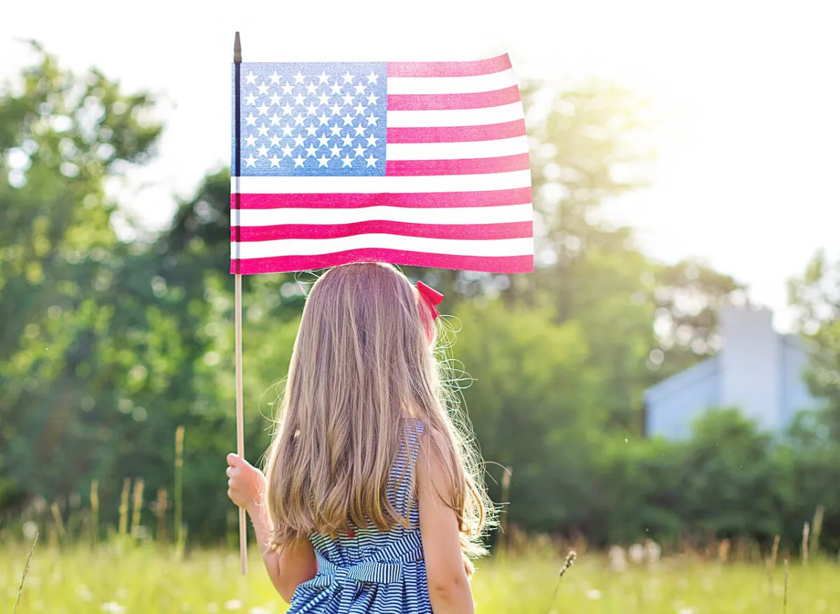 File photo of a young girl with an American flag. (JillWellington/Pixabay.com)