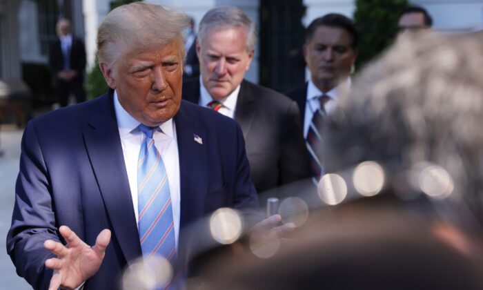 President Donald Trump speaks as White House chief of staff Mark Meadows (C) listens outside the White House on July 29, 2020. (Alex Wong/Getty Images)