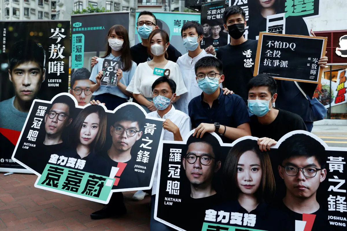 Agnes Chow, Anthony Wong Yiu Ming, Tiffany Yuen Ka-wai, Denise Ho Wan See, Lester Shum, Eddie Chu, Joshua Wong, and Gregory Wong pose during primary elections aimed for selecting democracy candidates, in Hong Kong on July 11, 2020. (Tyrone Siu/Reuters)