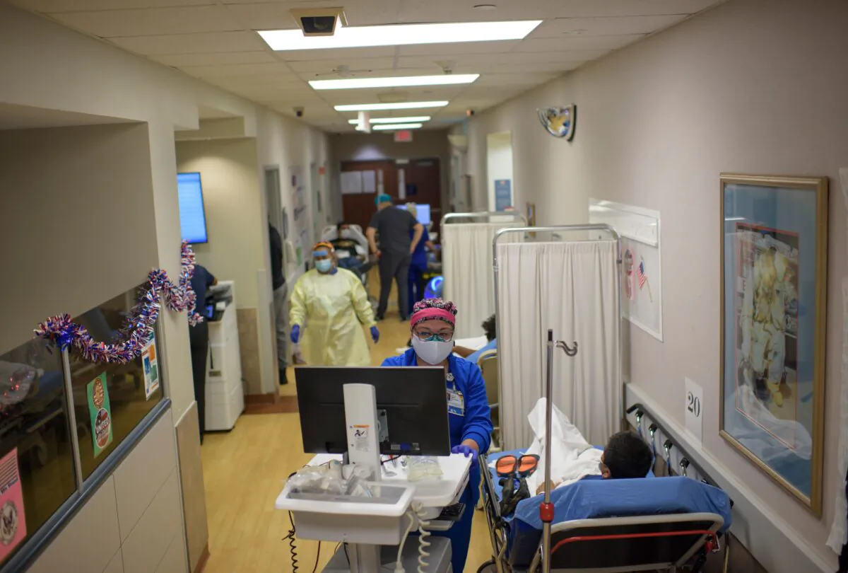 A healthcare worker talks to a patient in the ER at Oakbend Medical Center in Richmond, Texas, on July 15, 2020. (Mark Felix/AFP /AFP via Getty Images)